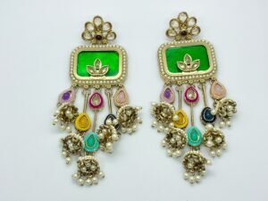“Traditional Kundan and Meenakari long earrings with pearl drops and colorful enamel detailing on white background”