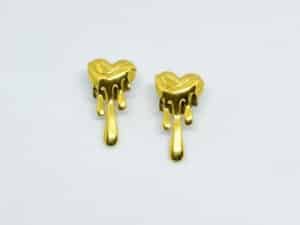 “Gold anti-tarnish heart drip earrings with shiny melted design on white background”