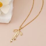 Gold bow pendant necklace for women with elegant ribbon design and gold chain